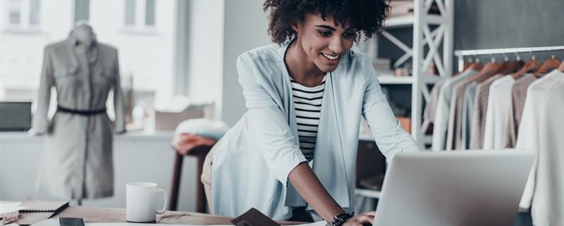 Businesswoman working on computer in shop