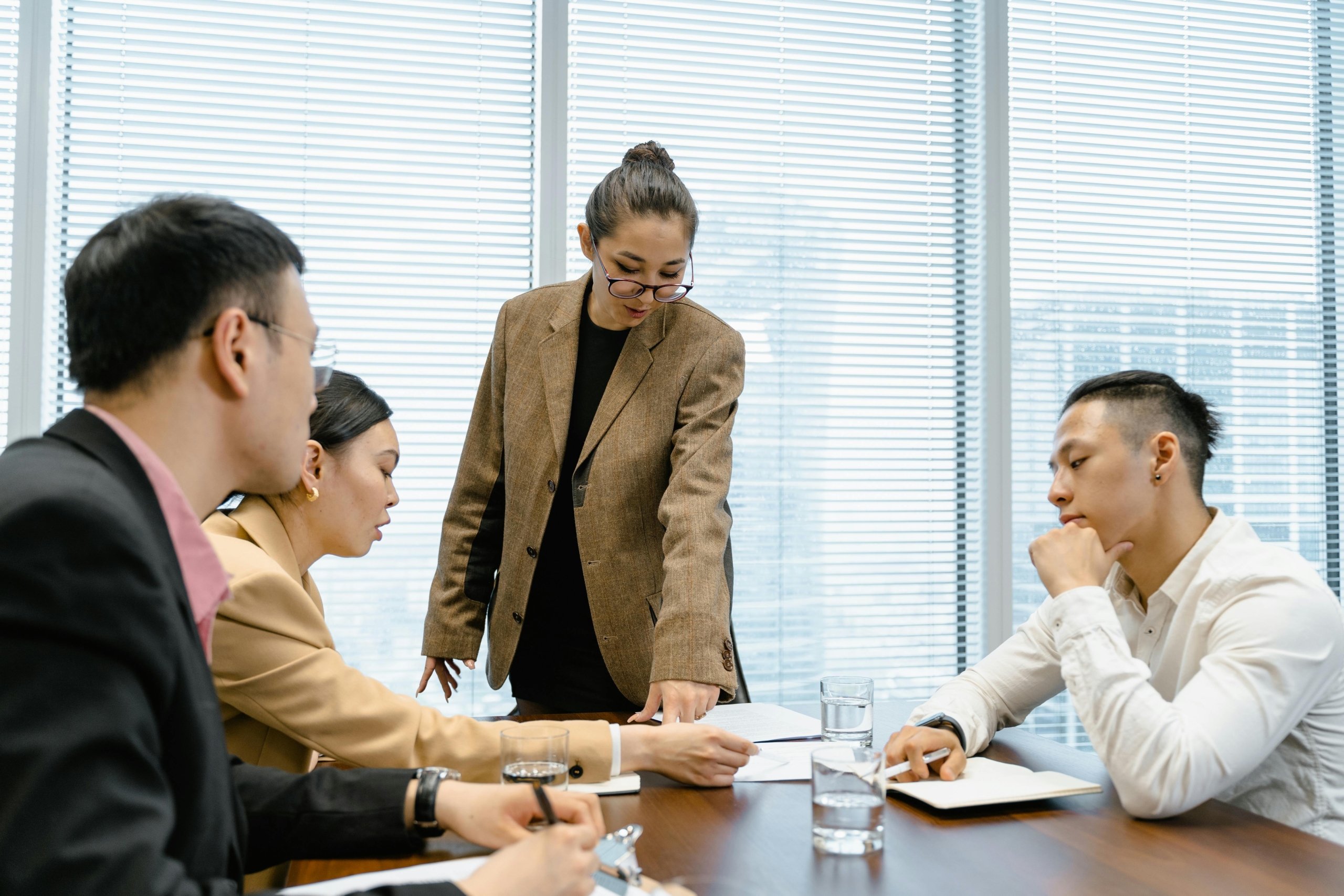 Four people having a discussion in an office Four people having a discussion in an office