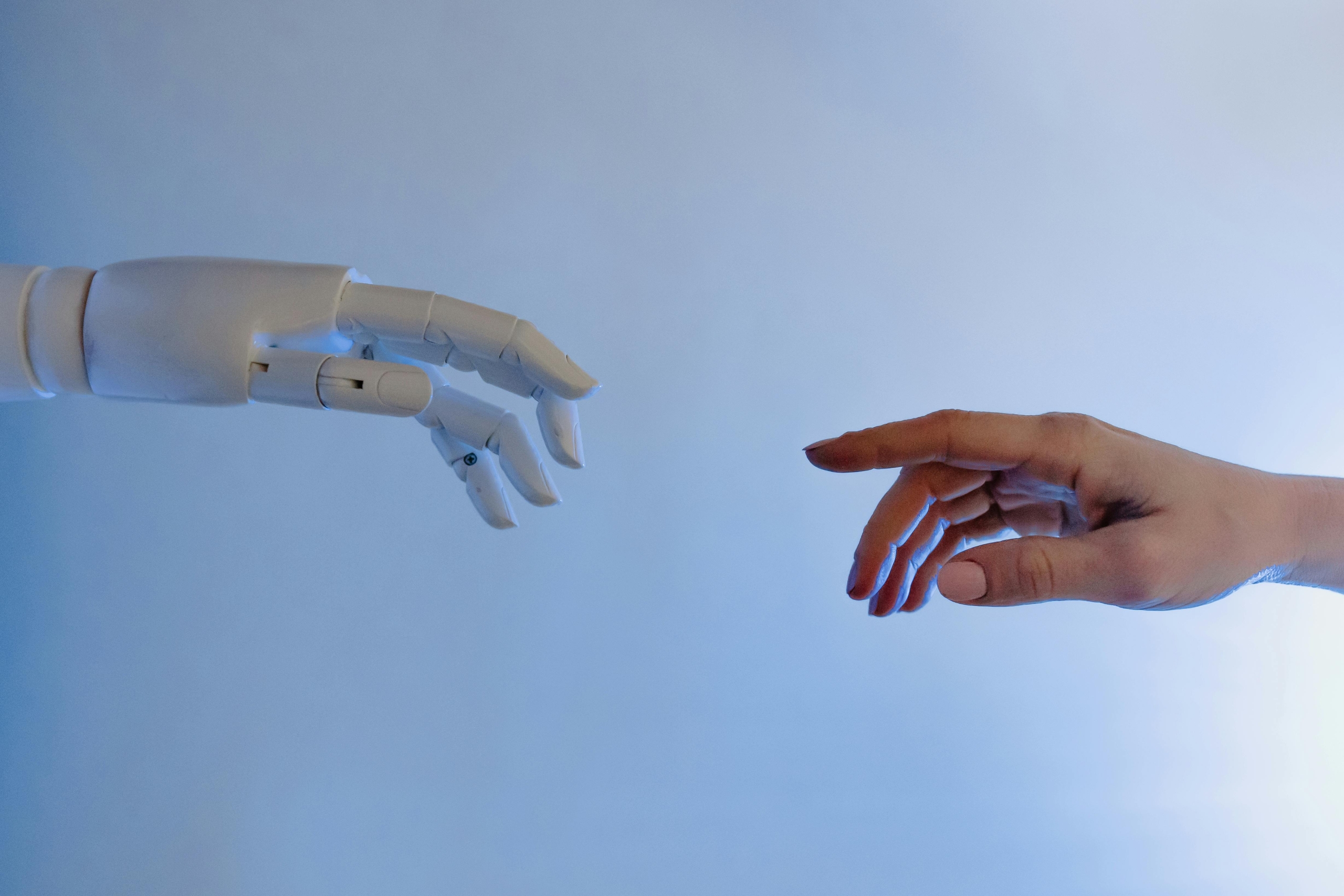 Robot and human hand reaching out to each other Robot and human hand reaching out to each other